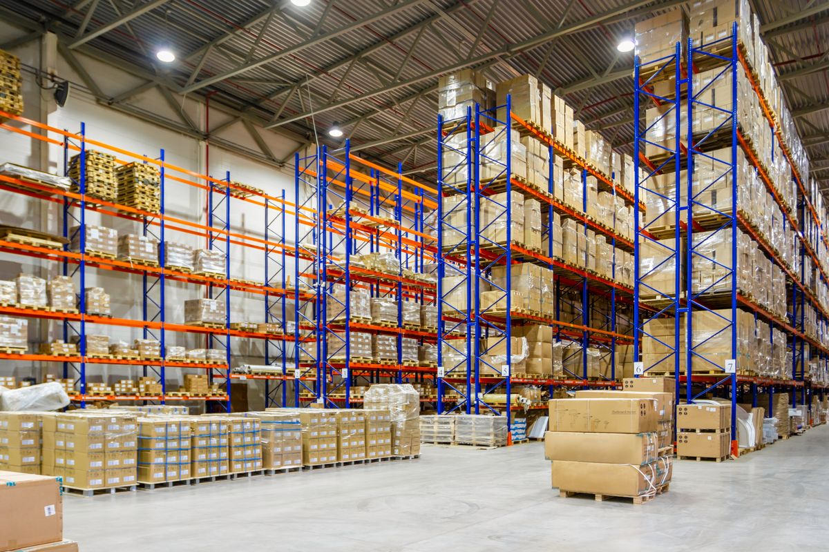 Warehouse racking and staging with pallets of goods.